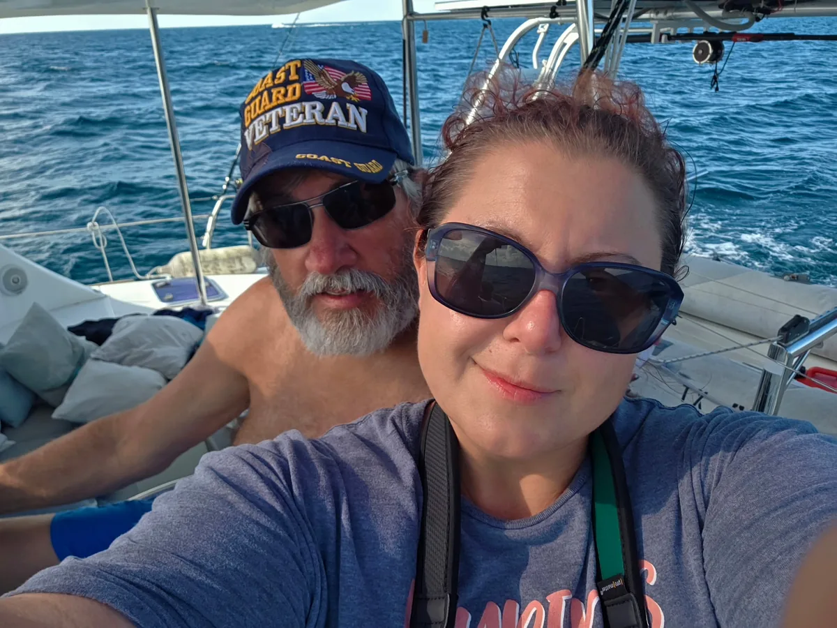 Captain Darryl and Brandy aboard Majik, open water behind them